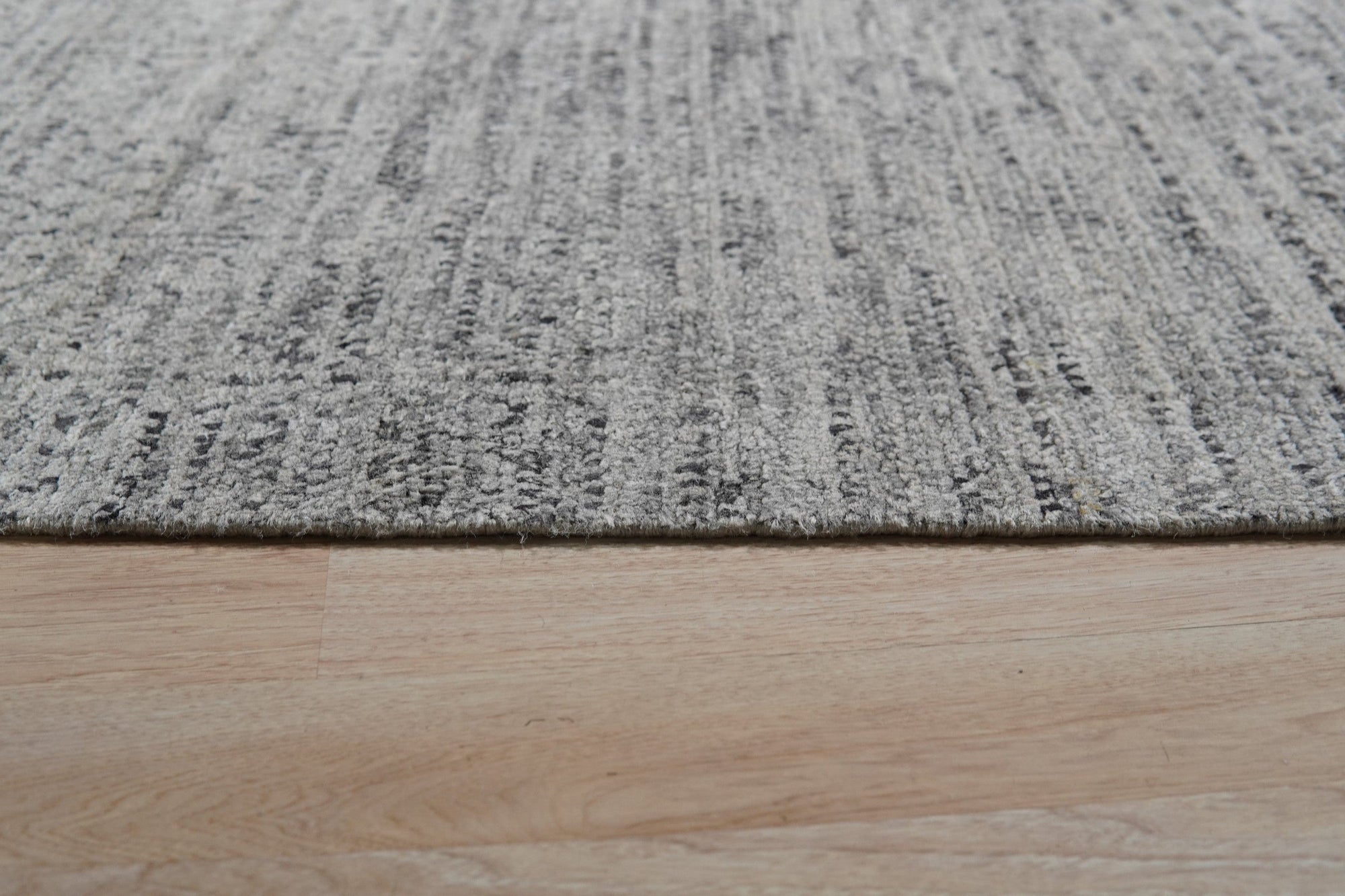 Refined Exquisite Gray Hand Knotted Silk Rug, a gray silk rug with intricate hand-knotted details, presented in a lifestyle setting showcasing its texture and subtle sheen.