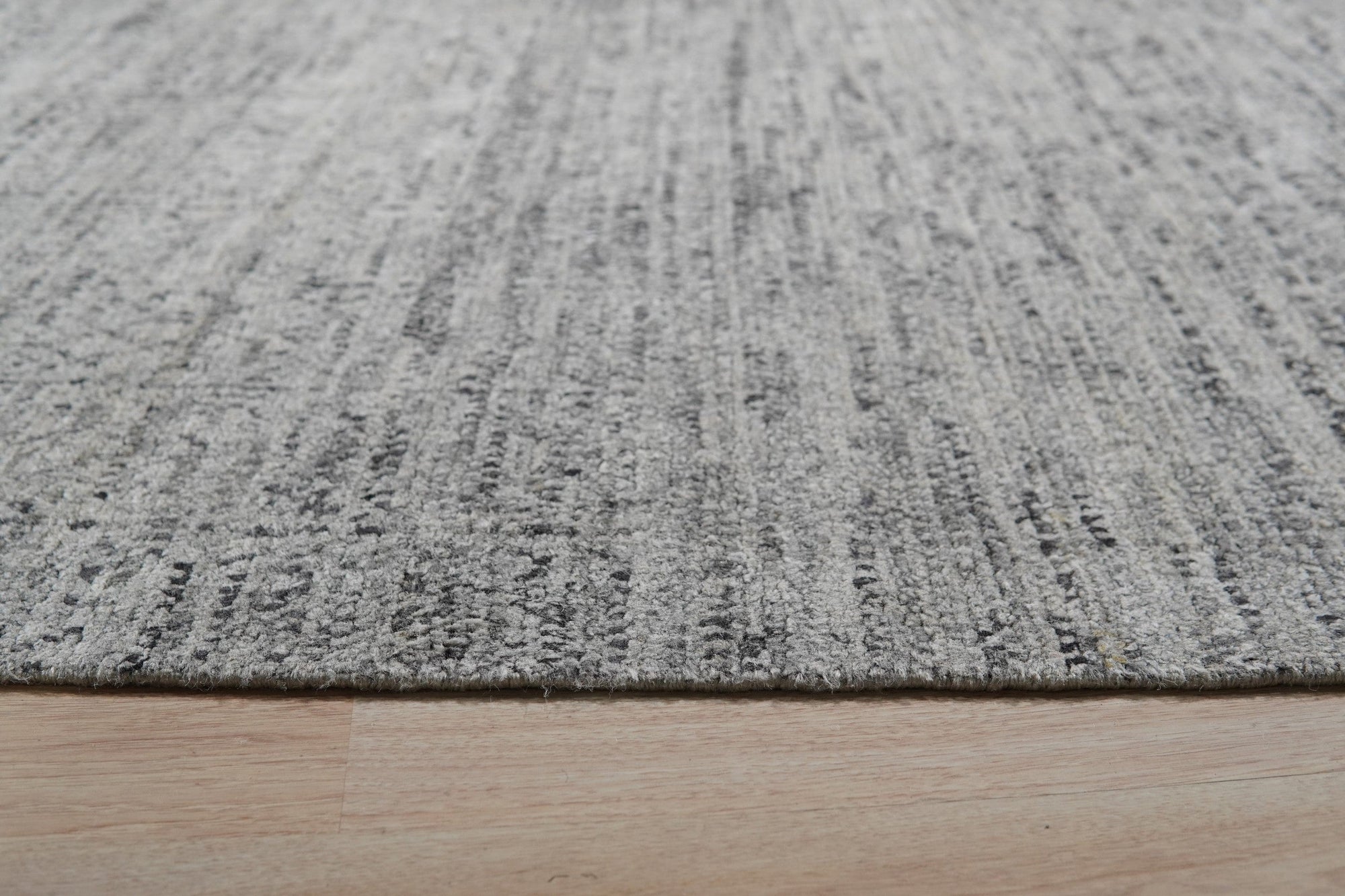 Refined Exquisite Gray Hand Knotted Silk Rug, its subtle gray hues and intricate hand-knotted construction displayed in a detailed close-up, showcasing the rug's luxurious texture.
