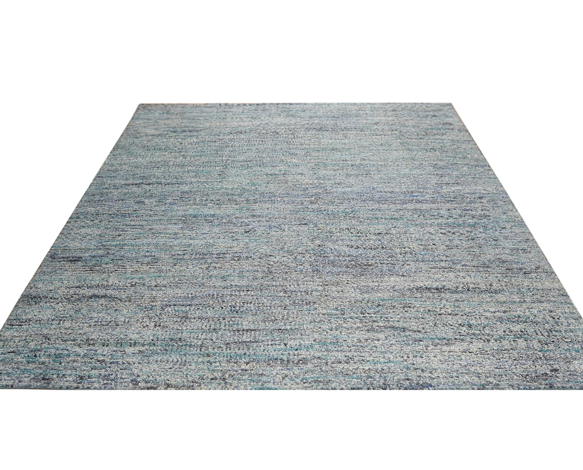 Refined Exquisite Gray Hand Knotted Silk Rug, its subtle sheen illuminating a complex geometric pattern, lies gracefully on a light wood floor, suggesting understated luxury and refined comfort in a contemporary space.