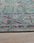 Celia Modern Green Hand Knotted Silk Rug, its luxurious sheen and intricate knotting evident, displayed in a bright, contemporary living room setting.
