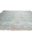 Celia Modern Green Hand Knotted Silk Rug, a lush green silk rug with a contemporary design, elegantly displayed in a living room setting.