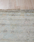 Ruby Fiona Ivory Hand Knotted Silk Rug, a luminous ivory silk rug with a subtle, elegant pattern, displayed within a softly lit interior setting, highlighting its luxurious texture and sophisticated design.