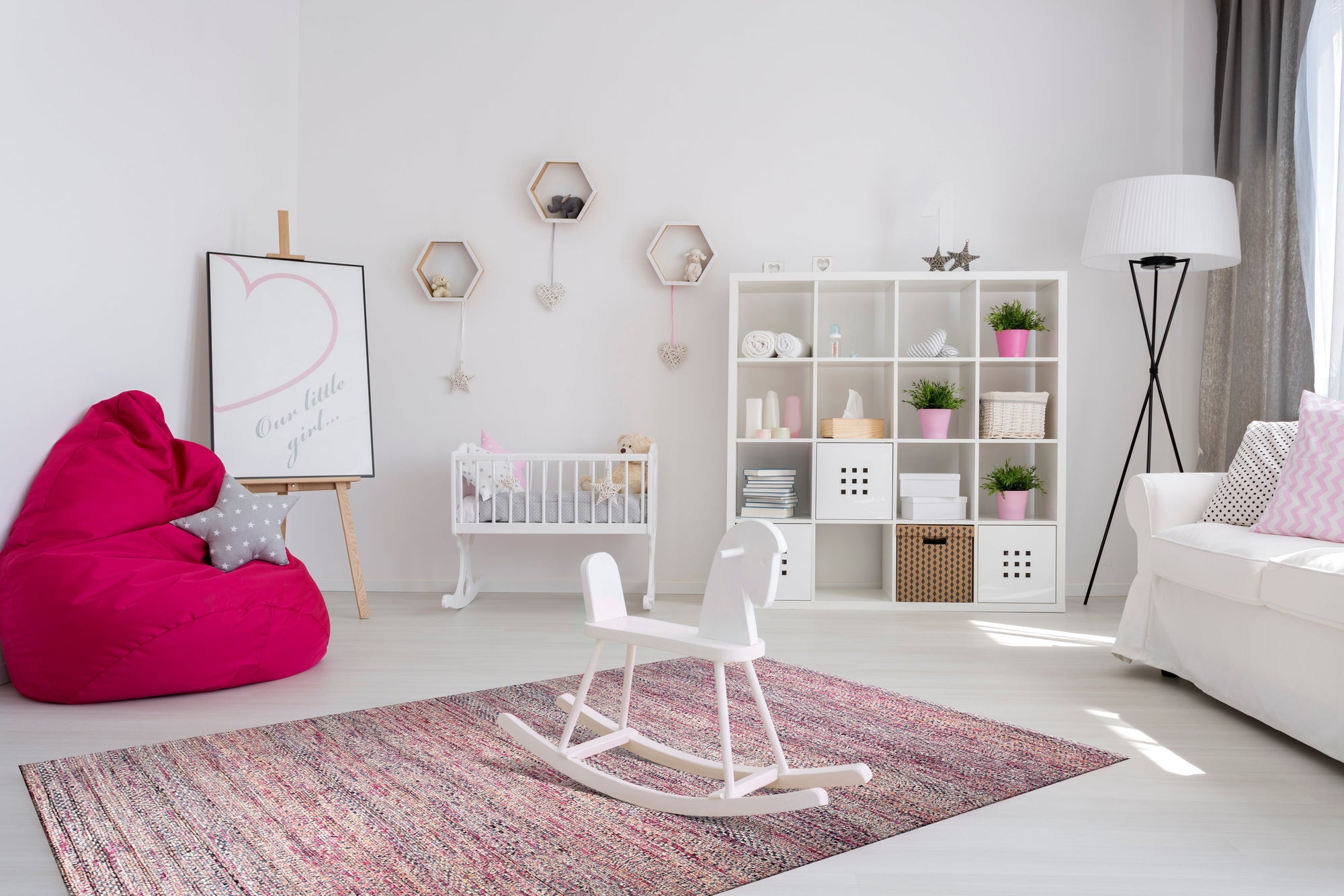 Nina Ruby Red Hand Knotted Silk Rug, rich ruby tones and intricate patterns hand-knotted in silk, lending luxurious texture to a well-lit living space.