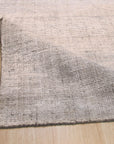 Talia Artisan Gray Handmade Rug, a close-up showcasing the intricate weave and subtle textures of the gray wool, emphasizing its handmade construction.