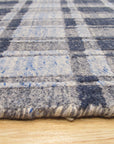 Radiant Tessa Blue Handmade Bamboo Silk Rug, showcasing its shimmering depths and intricate patterns in a bright, airy room setting. Cool blues interplay with subtle light variations across the rug's bamboo silk weave.