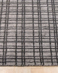 Here's the alt text based on your instructions:
Versatile Ella Silver Handmade Bamboo Silk Rug graces a bright, modern living space. Light reflects beautifully off the bamboo silk, highlighting subtle variations in the silver tone.