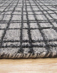 Versatile Ella Silver Handmade Bamboo Silk Rug, shimmering silver hues softly illuminate a modern living room, its subtle sheen and plush bamboo silk fibers creating a luxurious and inviting atmosphere.
