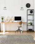 Penelope Isla Gray Handmade Bamboo Silk Rug, its shimmering gray surface reflecting light, showcasing the subtle sheen of bamboo silk in a modern living room setting.