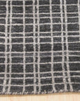 Penelope Isla Gray Handmade Bamboo Silk Rug, softly shimmering gray tones catch the light across its plush, hand-loomed bamboo silk surface, partially visible in a styled room setting.