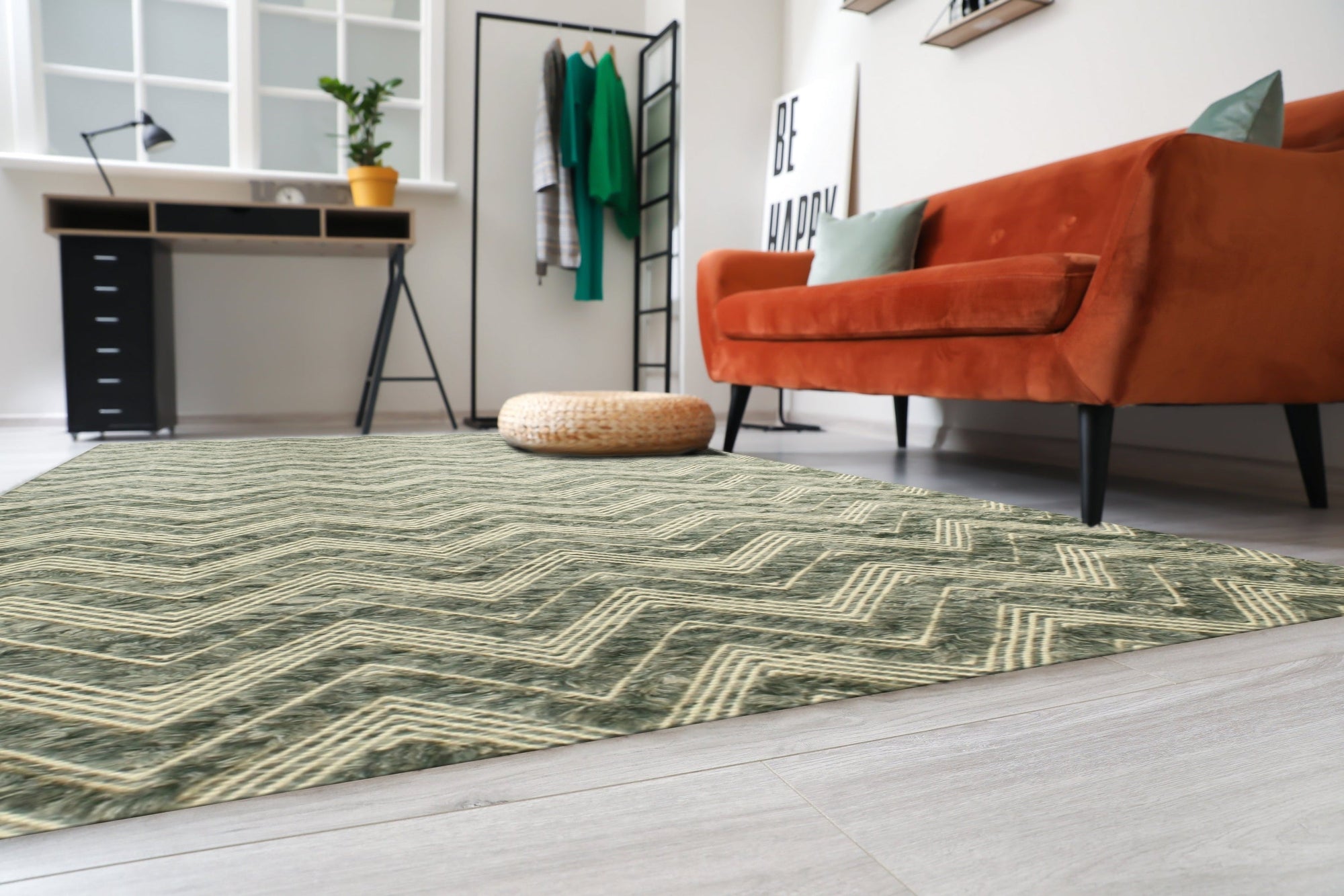 Charming Trara Green Handmade Wool Rug displayed on a light wood floor, its vibrant green wool pile and subtle pattern lending warmth and texture to the space.