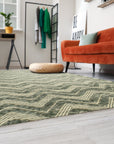 Charming Para Green Handmade Wool Rug, its soothing green tones and subtle pattern grounding a bright, airy living room with neutral furniture and natural light.