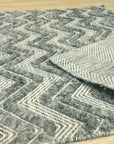 Charming Para Green Handmade Wool Rug, a verdant expanse of hand-knotted wool, anchors a light-filled room with its subtle texture and calming green hue.