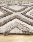 Elena Captivating Beige Hand Knotted Wool Rug, softly lit and showcasing intricate knotwork details, anchors a minimalist living room with creamy textures and warm wood accents.