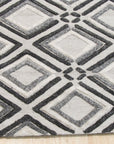 Chic Rhea Gray Hand Knotted Wool Rug, a textured gray wool rug with subtle geometric patterns, partially visible showcasing its pile and craftsmanship.