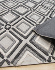 Chic Rhea Gray Hand Knotted Wool Rug, its subtle, sophisticated gray tones and hand-knotted construction visible within a warmly lit room setting.