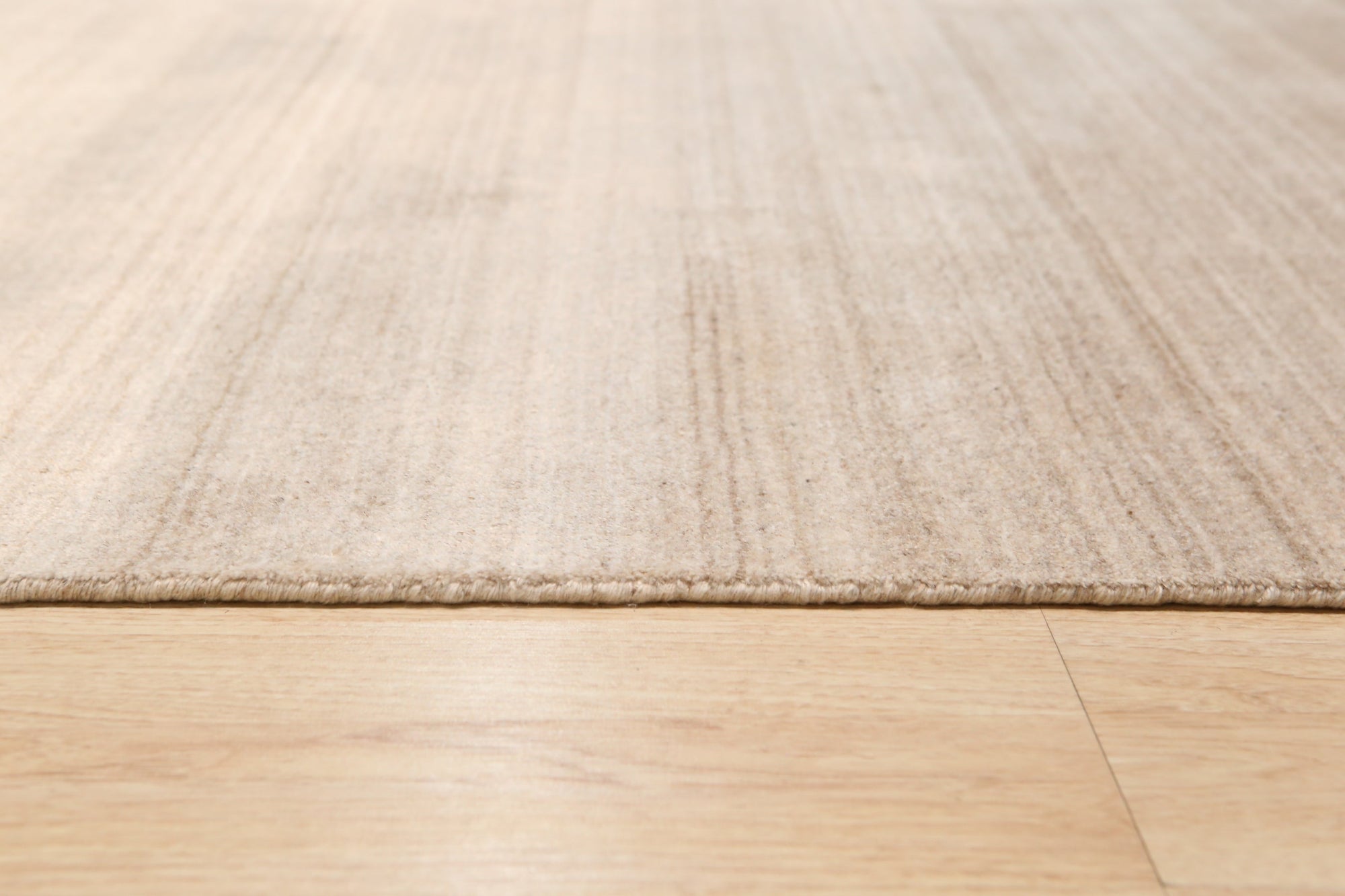 Elena Rhea Gold Handmade Wool & Viscose Rug, luxurious texture and subtle sheen showcased in a warm, inviting living space. Gold hues mingle with softer tones, highlighting the rug's intricate design and hand-knotted construction.