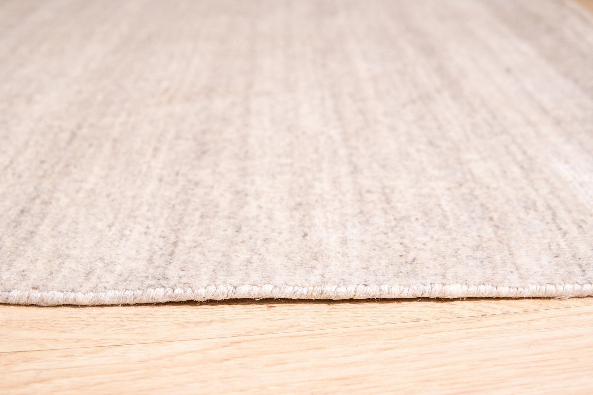 Maya Unique Beige Handmade Wool & Viscose Rug, its soft beige tones and subtle sheen adding warmth to a modern living space, showcasing the blend of wool and viscose fibers.
