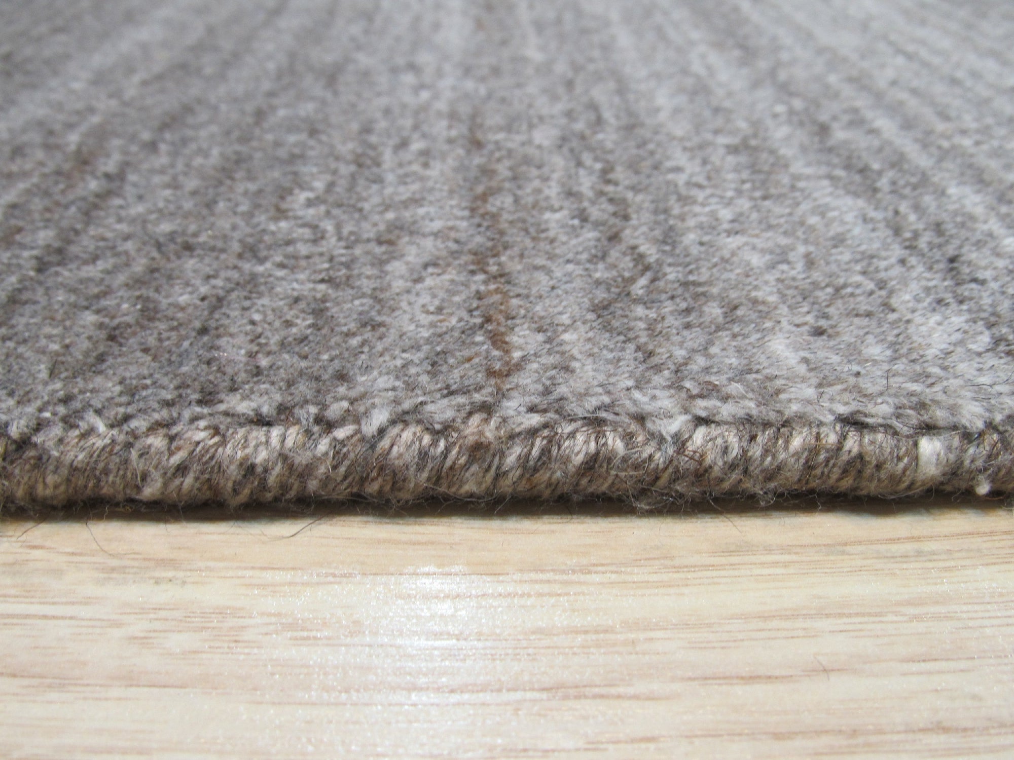 Louie Isla Brown Handmade Wool & Viscose Rug, a warm brown rug with subtle sheen, featuring a textured, abstract pattern, lending a touch of modern comfort to a contemporary living space.