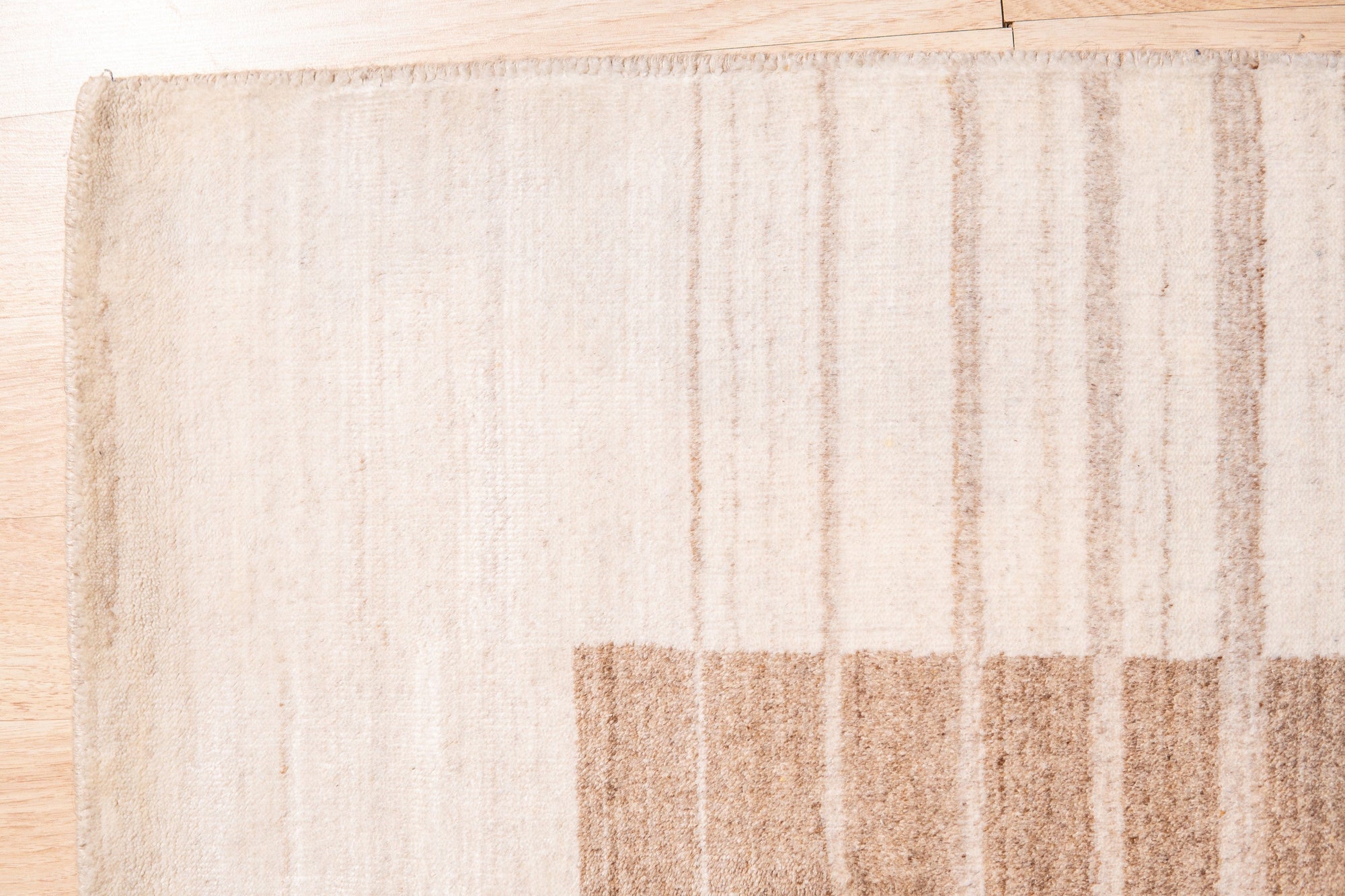 Rhea Quinn Brown Handmade Wool & Viscose Rug, featuring a warm, earthy brown palette with subtle sheen from viscose fibers, adds textured sophistication to a living room setting.