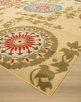 Cozy Chic Ivory Machine Made Rug, a soft ivory rug with subtle texture, partially visible under a modern light wood coffee table in a bright, airy living space.