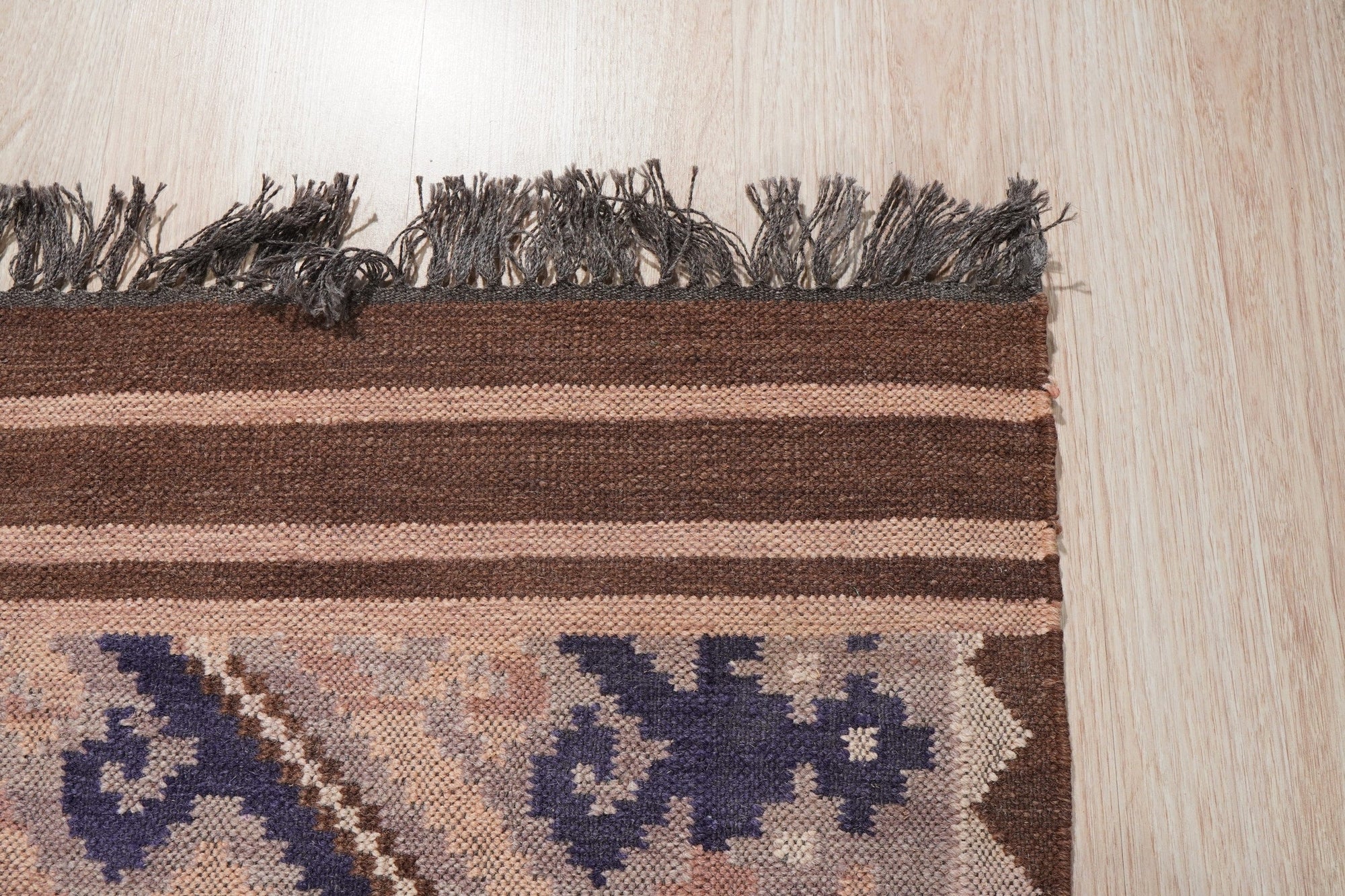 Penelope Jade Brown Flatweave Wool Rug, earthy tones blend in a lived-in living room; flatweave construction shows subtle texture.