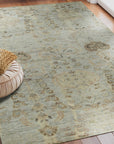 Nina Luxurious Ivory Hand Knotted Wool Rug, its plush ivory pile richly textured and subtly patterned, lays elegantly in a bright, modern living space.