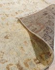 Nina Luxurious Ivory Hand Knotted Wool Rug, its intricate texture and soft ivory hues adding warmth to a sunlit living room with mid-century modern furniture and a vibrant green houseplant.