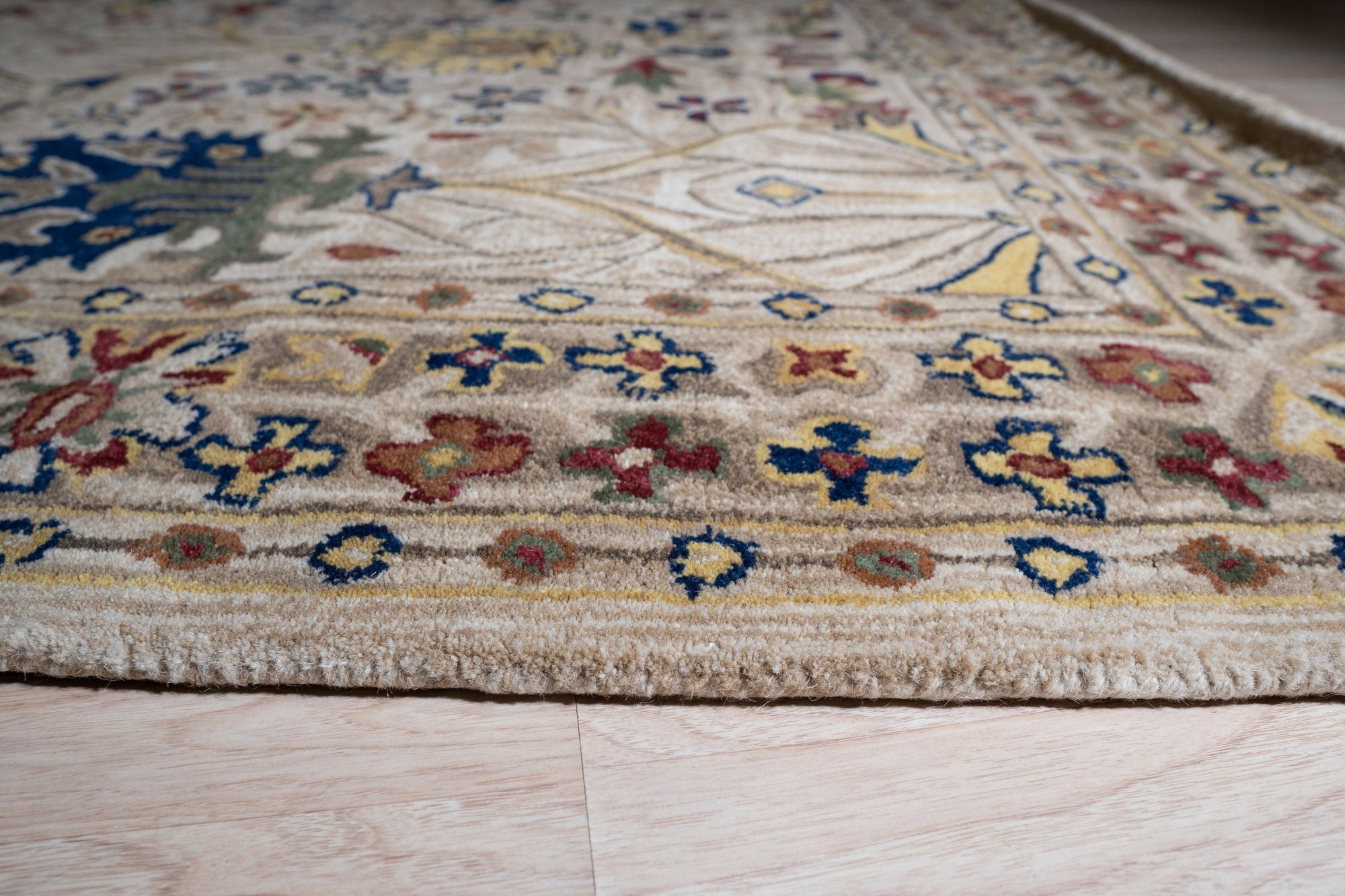 Graceful Exquisite Ivory Hand Tufted Wool Rug, seen in a bright living room setting, its plush ivory texture softening the space with subtle elegance.