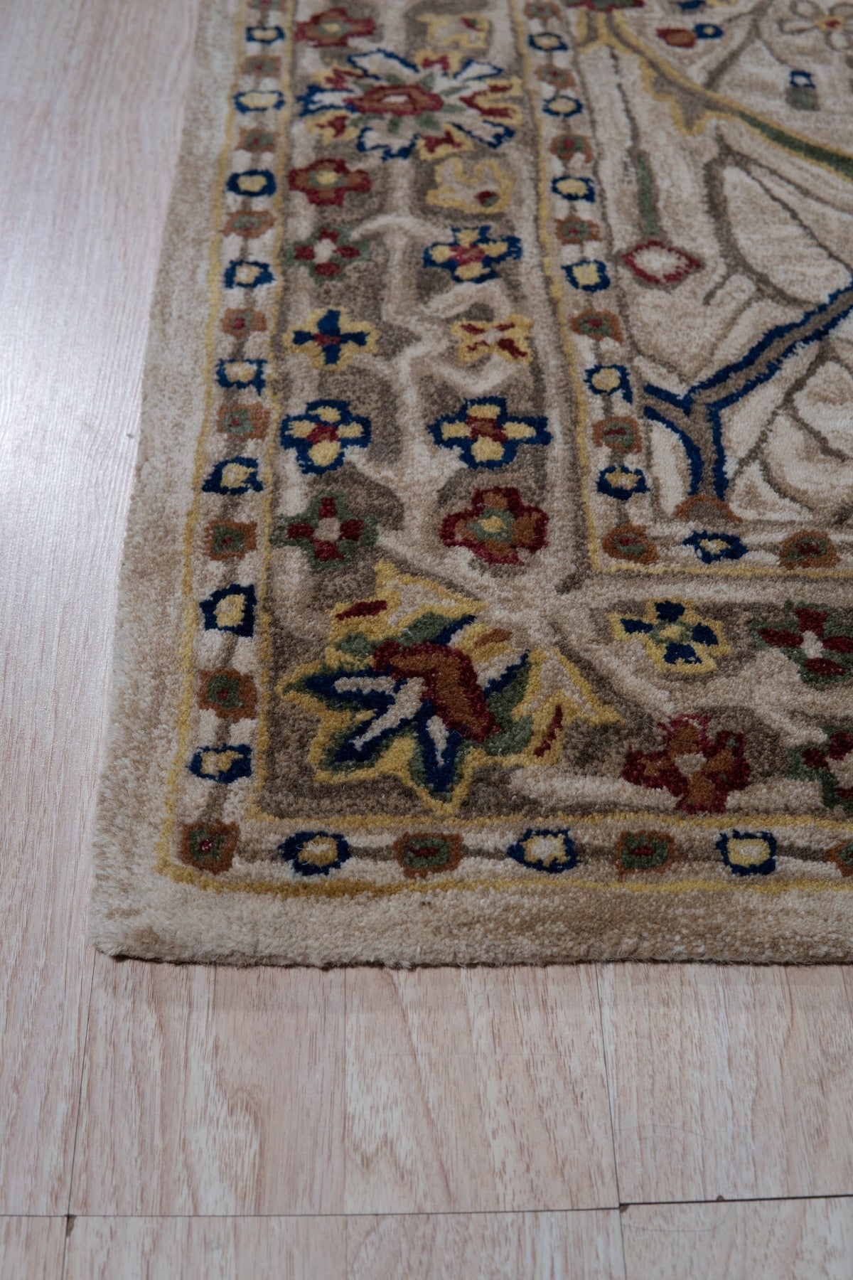 Graceful Exquisite Ivory Hand Tufted Wool Rug, seen in a living room setting, boasts a subtle textured pattern in soft ivory hues. Hand-tufted wool construction adds plush comfort and visual interest.