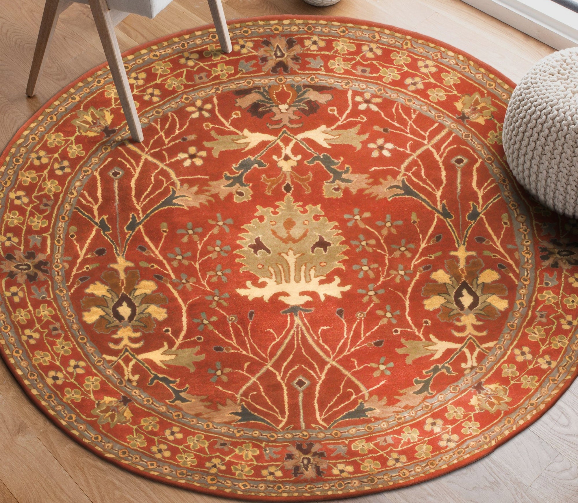Lydia Vibrant Red Hand Tufted Wool Rug, its swirling patterns and dense wool pile adding warmth and a splash of rich red to a light-filled living space.
