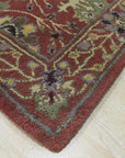 Lydia Vibrant Red Hand Tufted Wool Rug, displaying a warm and inviting splash of red. Hand-tufted construction highlights the texture and depth of the wool fibers, creating a plush, luxurious feel underfoot. The rug is seen in a bright, modern living space, complementing the neutral-toned furniture.
