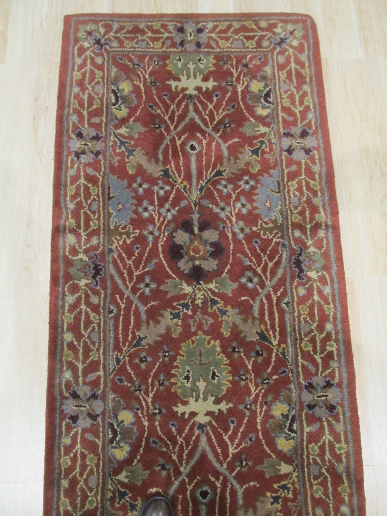 Lydia Vibrant Red Hand Tufted Wool Rug, its fiery reds and intricate hand-tufted texture warming a contemporary living space with neutral furniture and natural light.