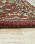 Lydia Vibrant Red Hand Tufted Wool Rug displayed in a modern living room setting. Warm red hues and soft wool texture complement a light-filled space, showcasing the rug's hand-tufted construction and adding a vibrant focal point to the décor.