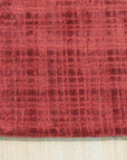 Sophie Iris Red Handmade Rug, rich red tones and intricate floral patterns create a vibrant focal point in a well-lit room.