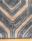 Maya Sophisticated Ivory Hand Tufted Wool & Viscose Rug, its creamy texture and subtle sheen enhancing a bright living space with minimalist furniture and warm wood accents.