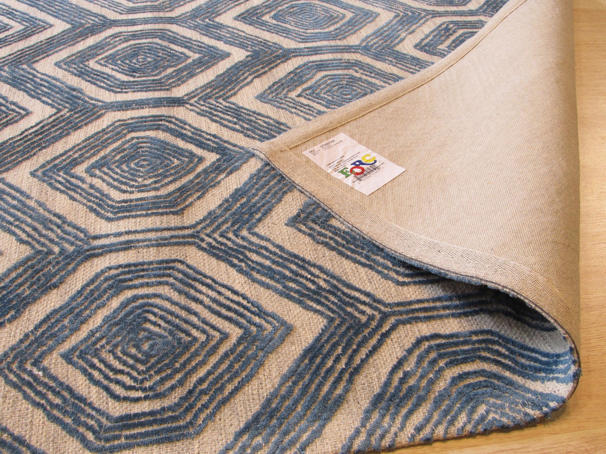 Maya Sophisticated Ivory Hand Tufted Wool & Viscose Rug, its subtle ivory hues and intricate hand-tufted texture lending an air of understated elegance to a modern living space.