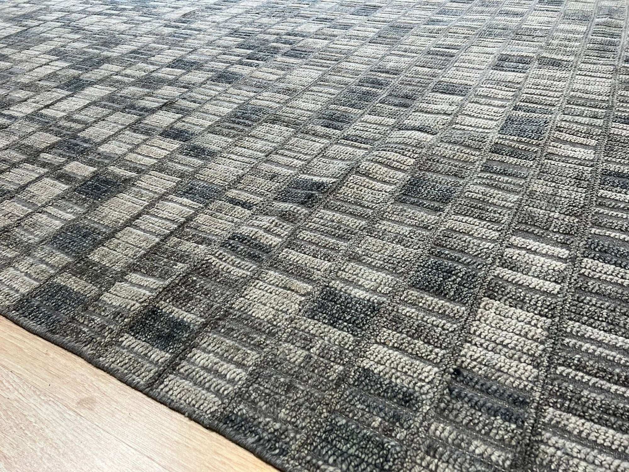 Tessa Sophisticated Gray Hand Knotted Wool Rug, a soft, luxurious gray wool rug with subtle texture, displayed in a bright, airy living space.