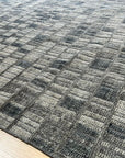 Tessa Sophisticated Gray Hand Knotted Wool Rug, a soft, luxurious gray wool rug with subtle texture, displayed in a bright, airy living space.