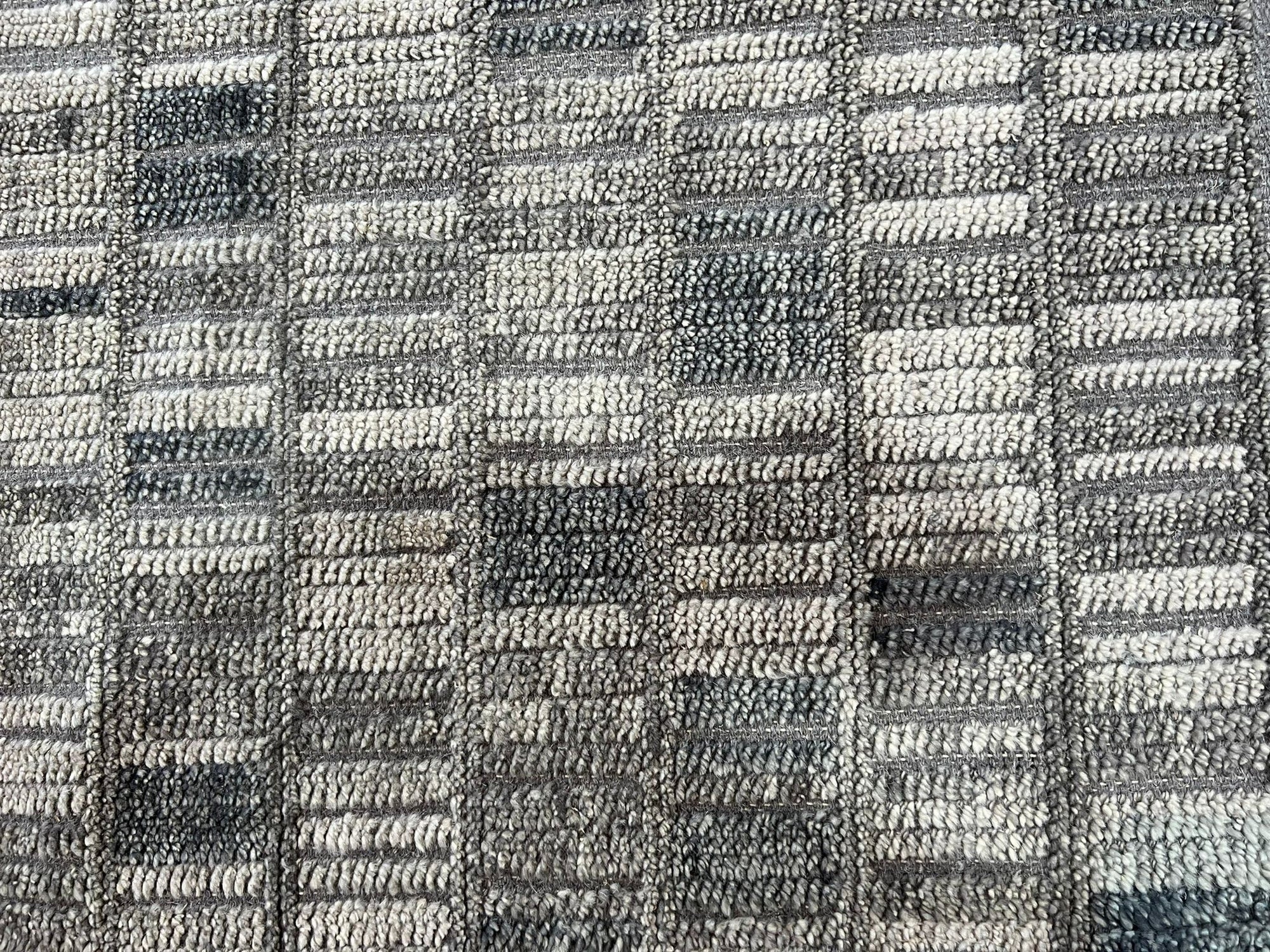 Tessa Sophisticated Gray Hand Knotted Wool Rug, its soft gray hues and hand-knotted texture grounding a modern living space.