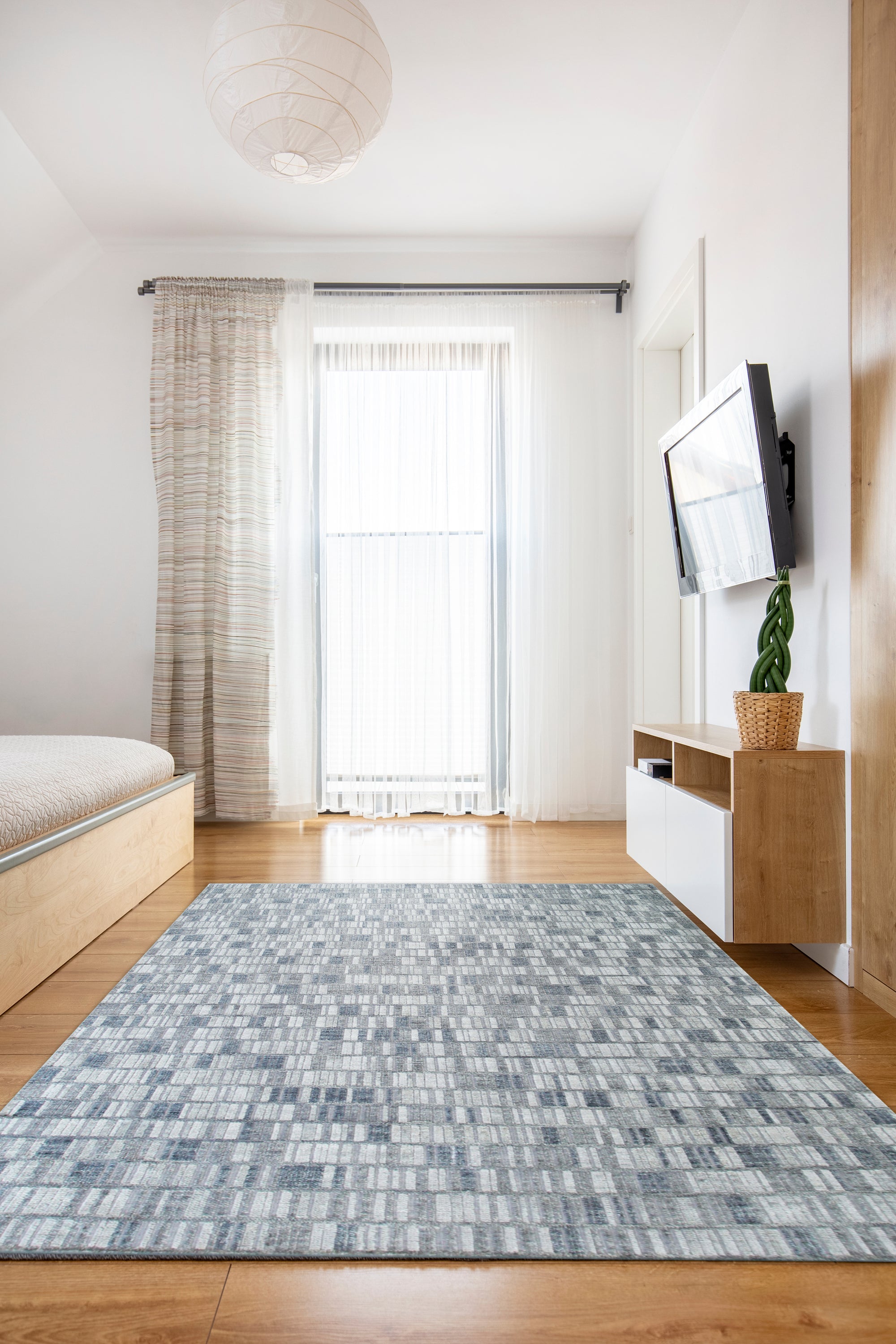 Tessa Sophisticated Gray Hand Knotted Wool Rug, showcasing its intricate hand-knotted construction and sophisticated gray hues in a styled room setting.