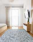 Tessa Sophisticated Gray Hand Knotted Wool Rug, showcasing its intricate hand-knotted construction and sophisticated gray hues in a styled room setting.