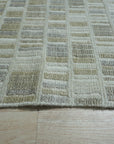Freya Timeless Ivory Hand Knotted Wool Rug, showcasing a soft, inviting texture and subtle pattern in a cozy living room setting.
