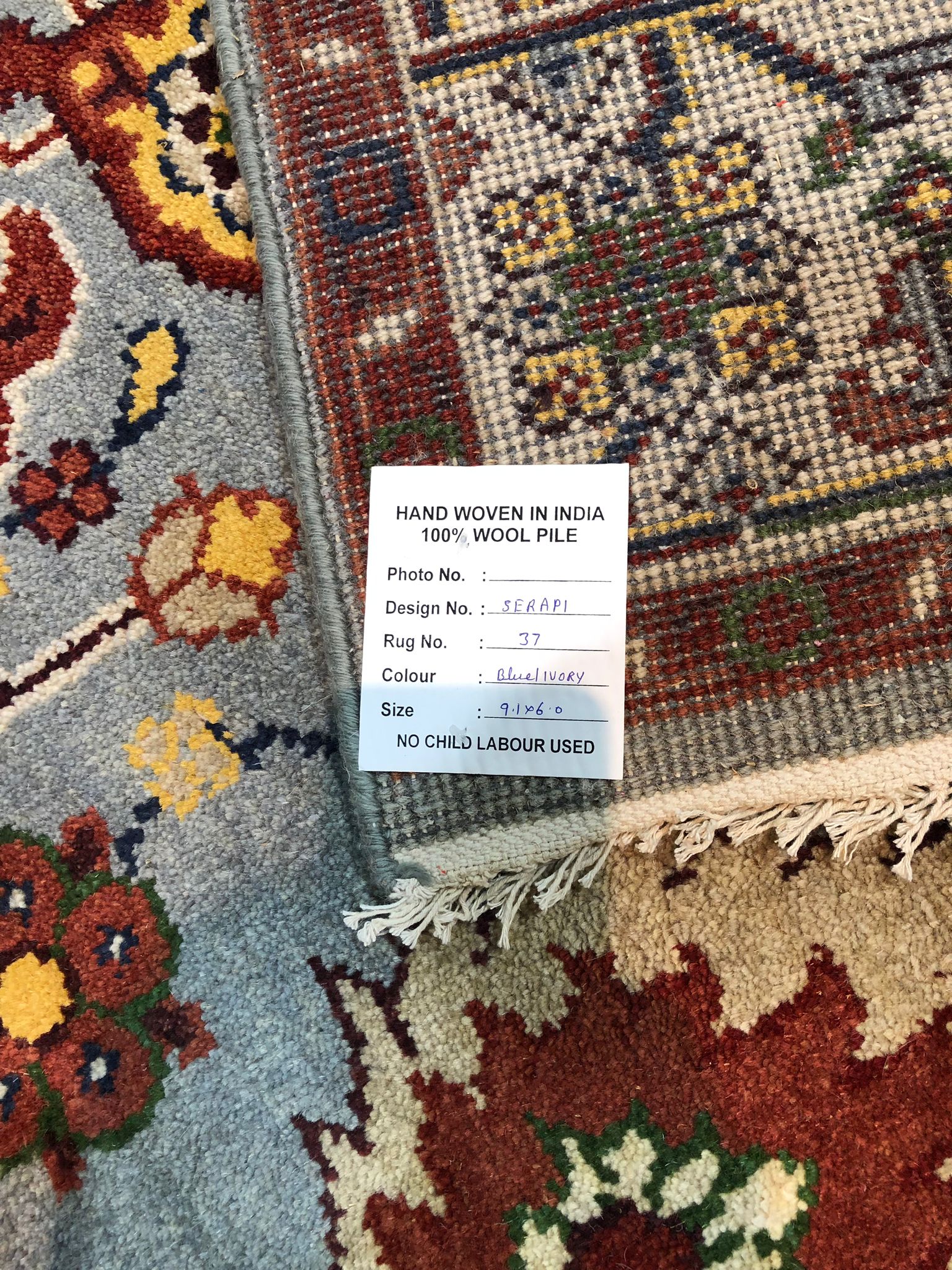 Vibrant Oriental Blue Hand Knotted Wool Rug displayed in a well-lit living space, its intricate floral motifs and deep blues adding a touch of classic elegance to the room.