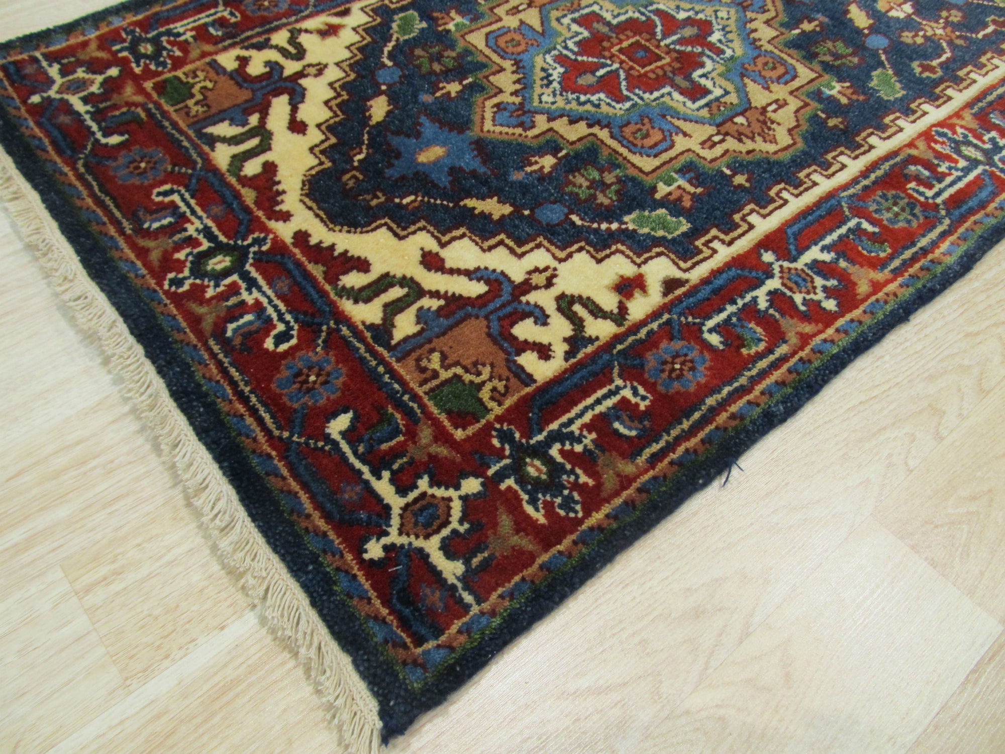 Ella Oriental Navy Hand Knotted Wool Rug, a navy wool rug with an intricate oriental design, displayed in a bright, modern living room.