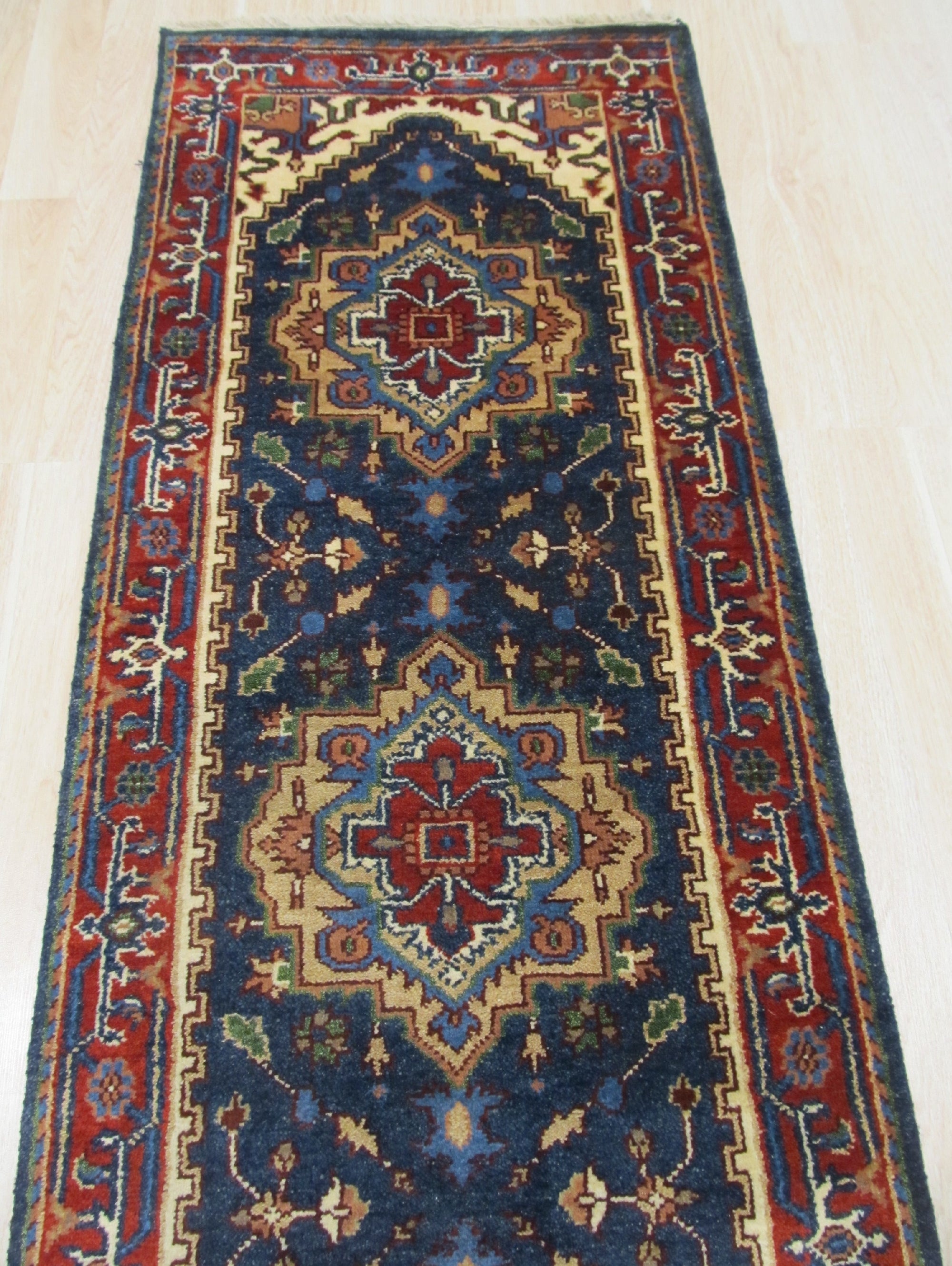 Ella Oriental Navy Hand Knotted Wool Rug, showcasing intricate patterns in deep navy and subtle creams, positioned in a well-lit room setting, suggesting a luxurious and inviting atmosphere.