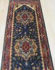 Ella Oriental Navy Hand Knotted Wool Rug, showcasing intricate patterns in deep navy and subtle creams, positioned in a well-lit room setting, suggesting a luxurious and inviting atmosphere.