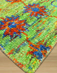 Sarrah Oriental Green Hand Knotted Sari-Silk Rug, a luxurious green and silk rug featuring an intricate oriental design, seen in a room setting demonstrating scale.