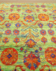 Sarrah Oriental Green Hand Knotted Sari-Silk Rug, luxurious green sari-silk rug with an intricate Oriental design, displayed in a well-lit room.