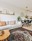 Cozy Harlow Navy Hand Knotted Wool Rug, a deep navy wool rug with a subtle, textured pattern, partially visible beneath light wooden furniture legs on a warm hardwood floor.