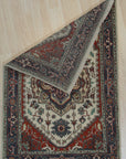 Cozy Harlow Navy Hand Knotted Wool Rug, a rich navy wool rug with subtle texture, complementing a modern living room with a light wood coffee table and a patterned accent chair.